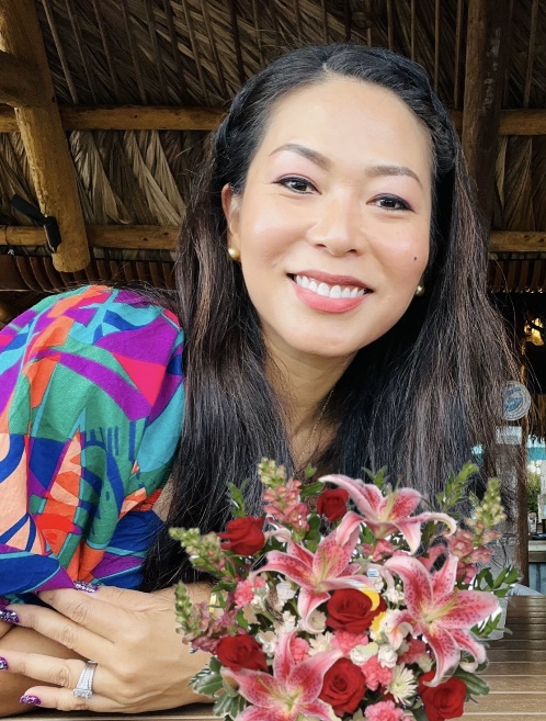 A person smiling with flowers